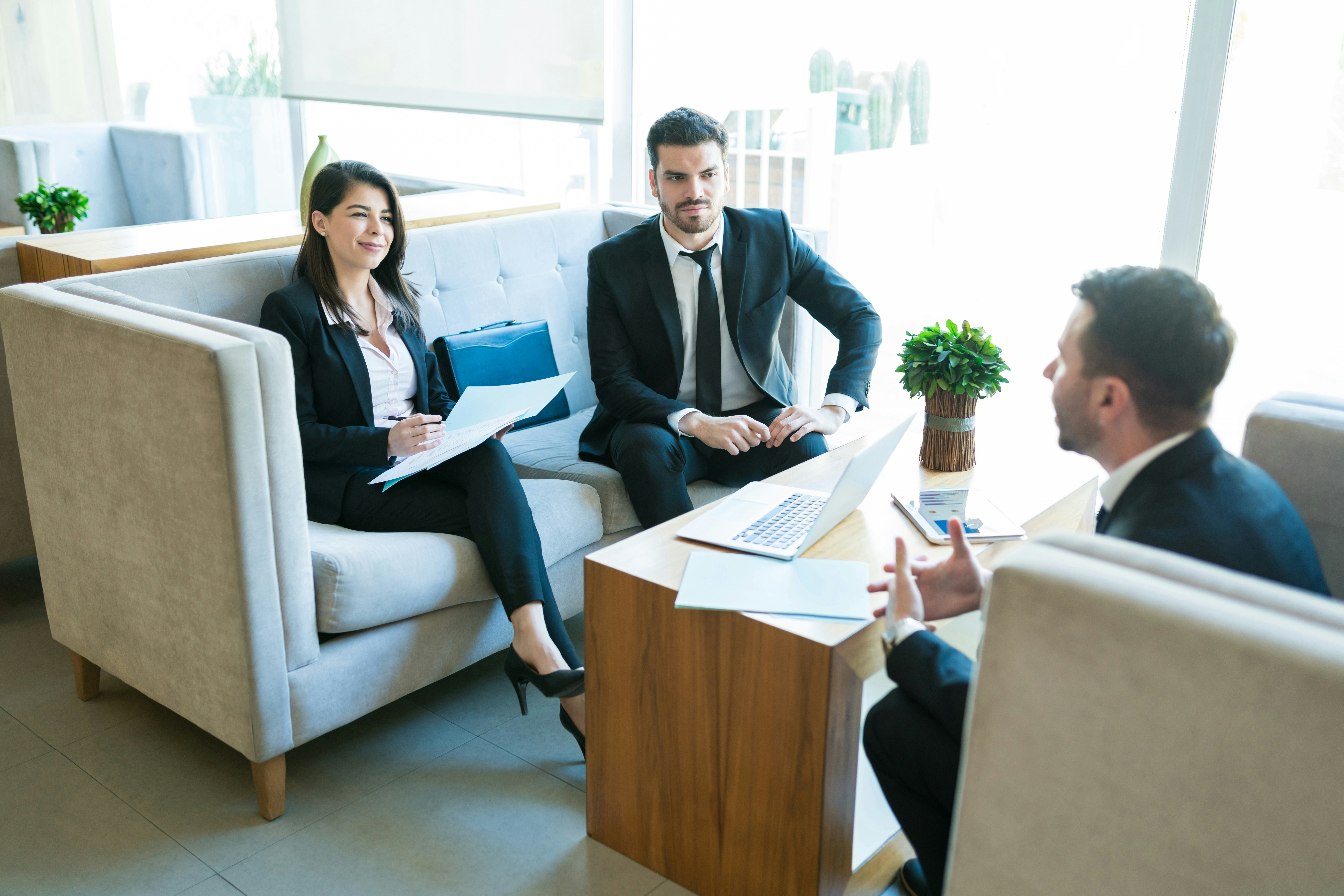 A group of young professionals sitting and chatting in a casual business setting, representing the human element of practicing law and Toronto criminal defence lawyers representing clients in DUI charges